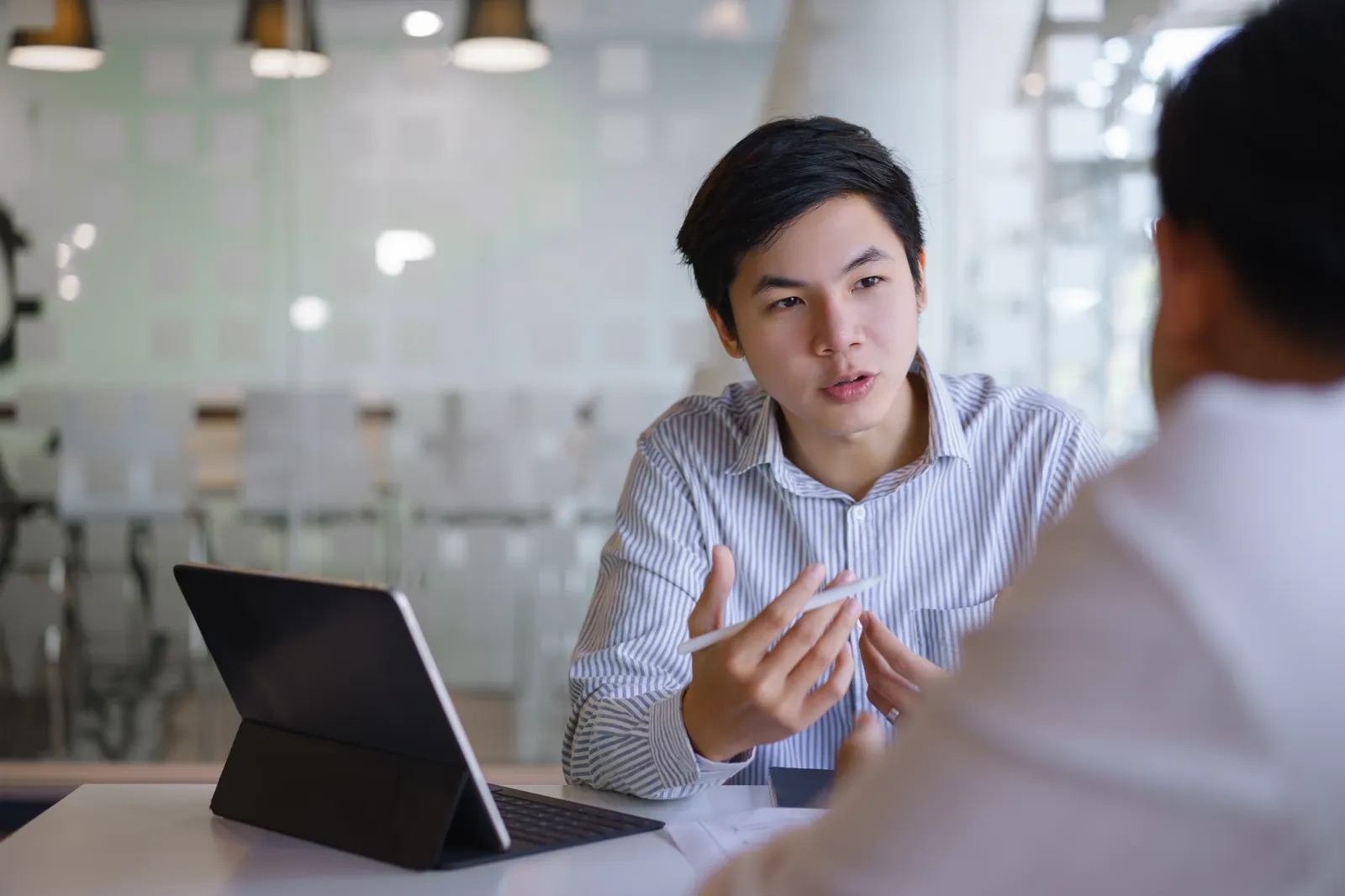 Two people meeting over coffee to talk through a space